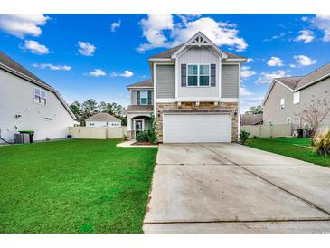 Two-story house with gray siding, stone accents, and a two-car garage at 5433 Merrywind Ct., Myrtle Beach, SC 29579