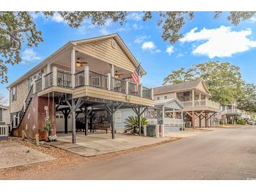 Charming elevated beach home with spacious deck and American flag at 6001-1604 S Kings Hwy., Myrtle Beach, SC 29575