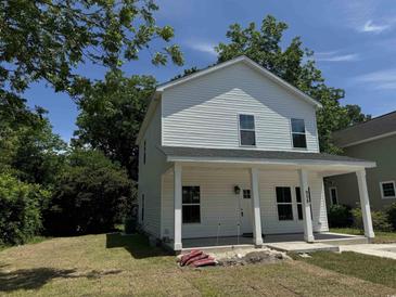 Two-story house with white siding, front porch, and landscaped lawn at 908 Merriman Rd., Georgetown, SC 29440
