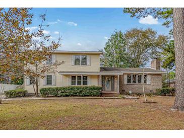 Charming two-story house with a well-maintained lawn at 917 9Th Ave. S, North Myrtle Beach, SC 29582