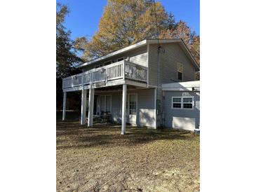 Gray two-story house with wrap around deck and large backyard at 1406 Hemingway Hwy., Hemingway, SC 29554