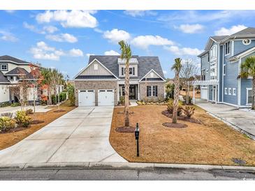 Charming two-story home with a brick and gray exterior, landscaped yard, and driveway at 1531 Biltmore Dr., Myrtle Beach, SC 29579