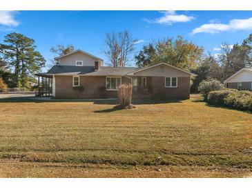 Brick ranch house with a large yard and detached garage at 2103 Loblolly St., Georgetown, SC 29440