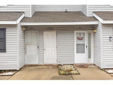 Three-unit building, light gray siding, with individual entrances and parking at 500 Fairway Village Dr. # 6B, Myrtle Beach, SC 29588