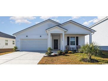 Charming white two-story home with a covered porch and attached garage at 822 Laconic Dr., Myrtle Beach, SC 29588