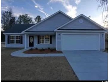 Newly constructed home with gray siding, two-car garage, and landscaping at Tbd 3 Mineral Springs Rd., Conway, SC 29527