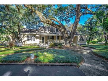 Charming one-story home with a large tree and well-manicured lawn at 1824 Laurel Trail # 1-B, Murrells Inlet, SC 29576