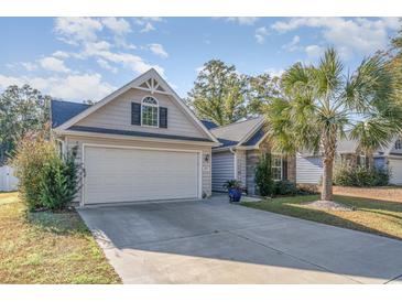 Charming two-story home with a welcoming front porch and landscaped yard at 239 Coachman Dr., Pawleys Island, SC 29585