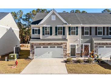 Charming two-story townhome with a one-car garage and landscaped front yard at 308 Golan Circle # C, Myrtle Beach, SC 29579