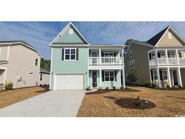 Charming two-story home with a mint green exterior, white garage door, and inviting front porch at 547 Slaty Dr., Myrtle Beach, SC 29588