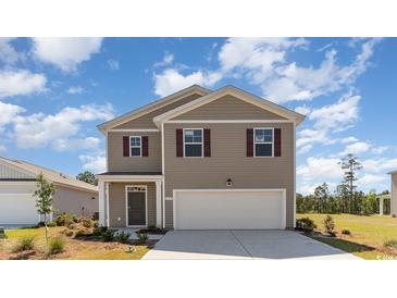 Charming two-story home with a welcoming front porch and landscaped yard at 620 Grateful Dr., Little River, SC 29566