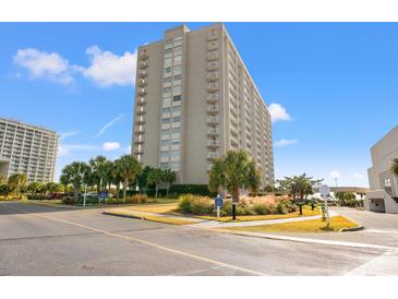 Exterior view of a high-rise condominium building with balconies and landscaping at 9820 Queensway Blvd. # 903, Myrtle Beach, SC 29572