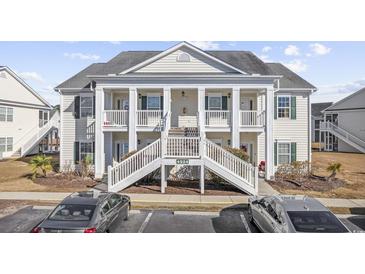 Attractive two-story condo building with balconies and front steps at 4924 Pond Shoals Ct. # 101, Myrtle Beach, SC 29579
