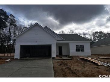 New construction home with white siding, gray roof, and attached two-car garage at 672 Castillo Dr., Loris, SC 29569