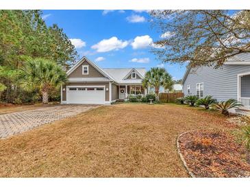Attractive single-story home with a paved driveway and manicured lawn at 317 Goddard Ln., Murrells Inlet, SC 29576