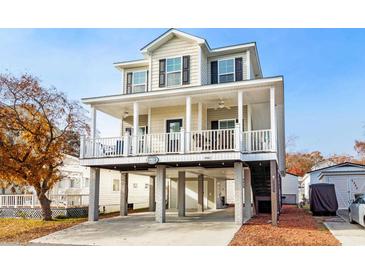 Two-story house with a large deck, attached garage, and ample parking at 6001 - 5326 S Kings Hwy., Myrtle Beach, SC 29575