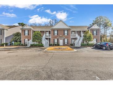Two-story brown building with stairs and parking at 712 Algonquin Dr. # A, Pawleys Island, SC 29585