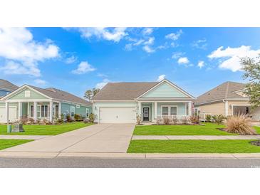 Charming light blue home with a covered porch and attached garage at 935 Piping Plover Ln., Myrtle Beach, SC 29577