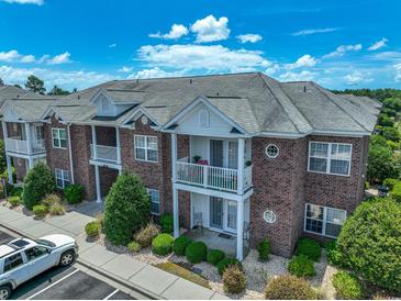 Brick building with balconies, landscaping, and ample parking at 2033 Silvercrest Dr. # 21-A, Myrtle Beach, SC 29579