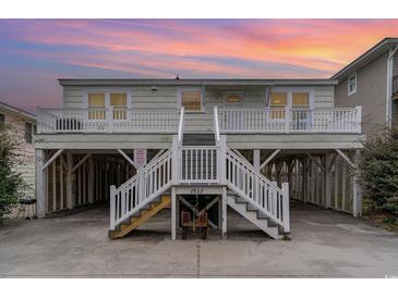 Elevated beach house with two stories, white railings, and stairs at 2802 N Ocean Blvd., North Myrtle Beach, SC 29582