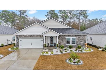 Single-story home with stone accents and a two-car garage at 4551 Day Lily Run St., Myrtle Beach, SC 29579