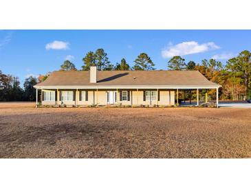 One-story house with covered porch and large yard at 971 Mcnabb Rd., Loris, SC 29569