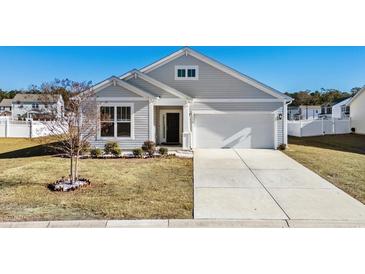 Gray siding house with a two-car garage and manicured lawn at 1378 Tessera Way, Myrtle Beach, SC 29579