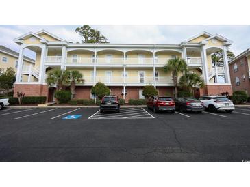 Three-story condo building with ample parking and landscaping at 4161 Hibiscus Dr. # 203, Little River, SC 29566