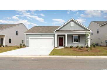 Gray exterior boasts a two-car garage and welcoming front porch at 453 Acosta Circle, Conway, SC 29527