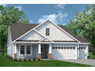 Two-story home with light blue siding, brick accents, and a two-car garage at 5035 Cambria Ct., Little River, SC 29566