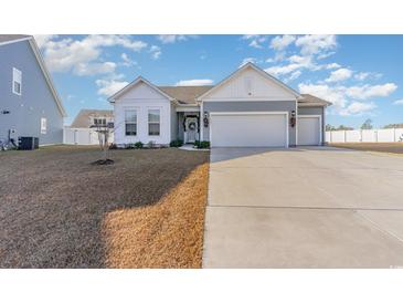 Two-story Craftsman home with gray siding, white accents, and a two-car garage at 5037 Sassari St., Myrtle Beach, SC 29579