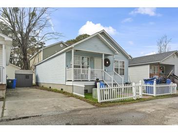 Cute light blue house with white picket fence and small front yard at 815 Rogers Dr., Myrtle Beach, SC 29577