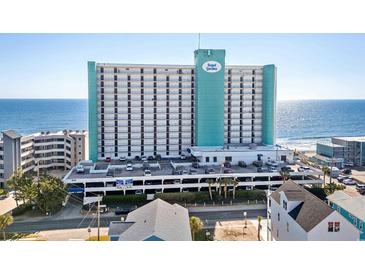 Oceanfront high-rise building with parking and surrounding buildings at 1210 N Waccamaw Dr. # 404, Garden City Beach, SC 29576