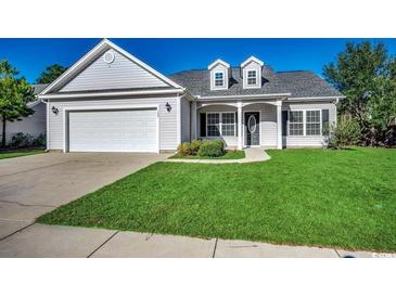 One-story house with attached garage, manicured lawn, and neutral siding at 100 Barons Bluff Dr., Conway, SC 29526