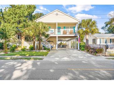 Two-story beach home with elevated parking and a landscaped yard at 206 Hillside Dr. S, North Myrtle Beach, SC 29582