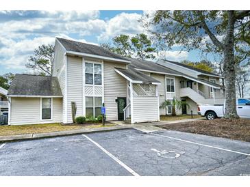 Front view of a light beige multi-unit building with parking at 4450 Little River Inn Ln. # 602, Little River, SC 29566