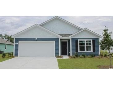 Curb appeal abounds in this charming house featuring a blue exterior, white accents, and a two-car garage at 552 Duvall St., Longs, SC 29568