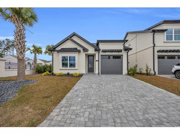 Craftsman style home with gray garage door and paved driveway at 6703 Ocean Breeze Loop, Myrtle Beach, SC 29577