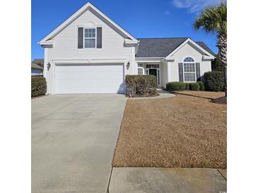 Charming one-story house with a two-car garage and well-maintained lawn at 729 Woodcrest Way, Murrells Inlet, SC 29576