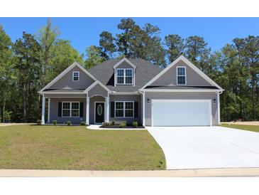 Two-story house with gray siding, white garage door, and landscaped lawn at Tbd 15 Mineral Springs Rd., Conway, SC 29527