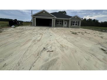Newly constructed home with a two-car garage and spacious front yard at Tbd 16 Mineral Springs Rd., Conway, SC 29527
