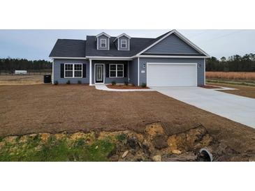 Gray vinyl sided house with attached garage and small yard at Tbd11 Mineral Springs Rd., Conway, SC 29527