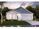 Charming two-story home with a white and blue exterior, two-car garage, and landscaping at Tbd2 Kapalua Loop, Little River, SC 29566
