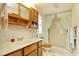 Clean bathroom with wood cabinets, a shower, and a vanity at 894 S Marlin Circle, Murrells Inlet, SC 29576