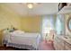 Bright bedroom with yellow floral wallpaper, double bed and dresser at 894 S Marlin Circle, Murrells Inlet, SC 29576