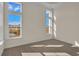 Bright bedroom with large windows, neutral carpeting, and natural light at 1228 Colusa Ct., Little River, SC 29566