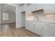 Basement kitchenette with white cabinets and quartz countertops at 43 Melbourne Ct., Murrells Inlet, SC 29576