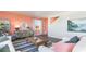 Living room with coral accent wall, white sofas, and a coffee table at 538 Strawberry Field Way, Galivants Ferry, SC 29544