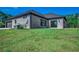Gray brick house with a gray roof and attached garage at 209 Brush Ct., Little River, SC 29566