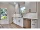Kitchen sink and dishwasher with white cabinets and quartz countertops at 209 Brush Ct., Little River, SC 29566